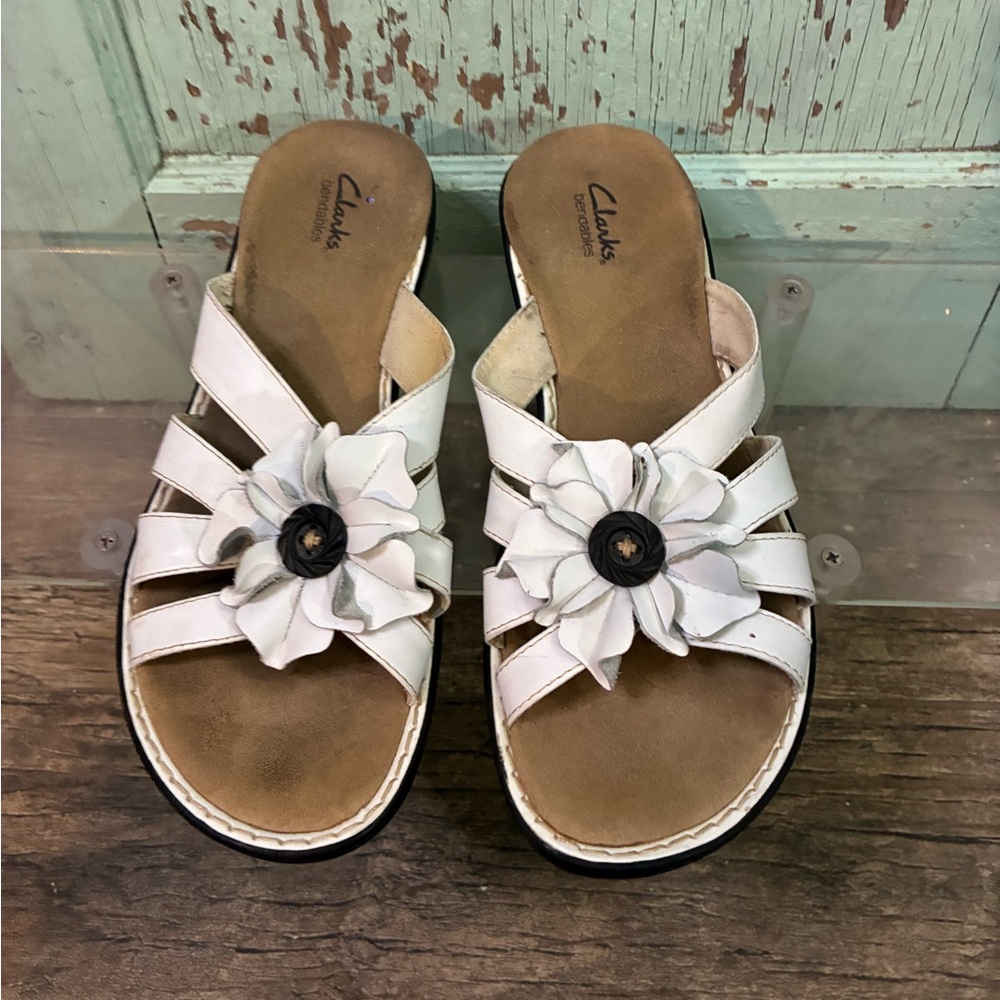 Women’s white Clarks slip on sandals with flower detail